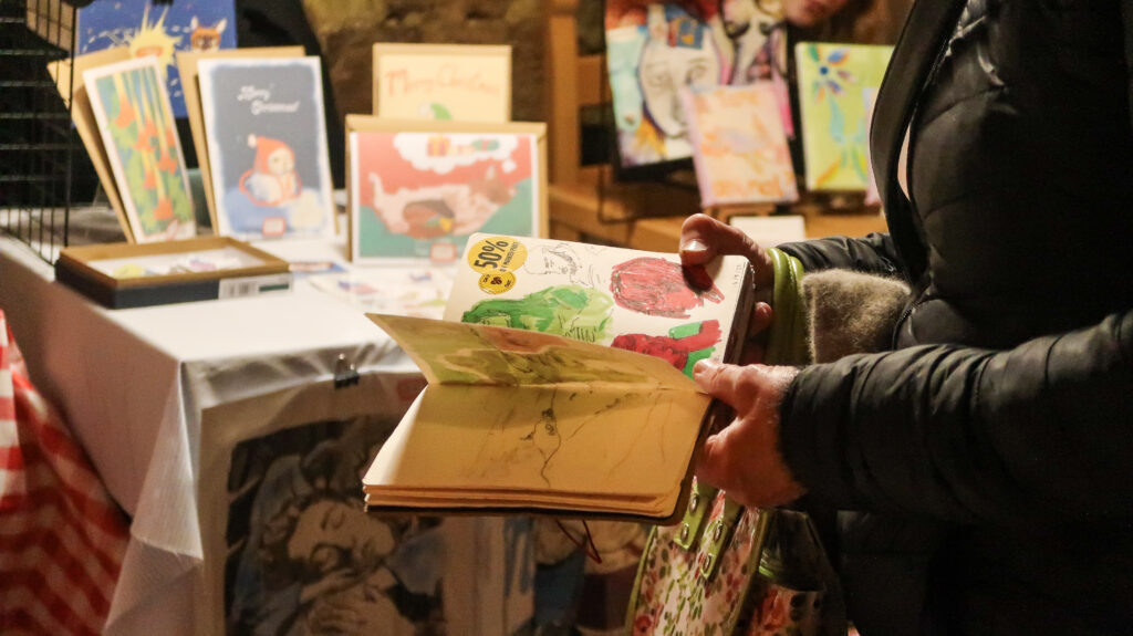 Medium shot of a sketchbook by Henry Murphy at the Jingle Jangle Market 2025